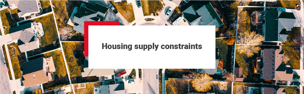 View of houses in an upmarket neighbourhood - 'Housing supply constraints' has been positioned over the image.